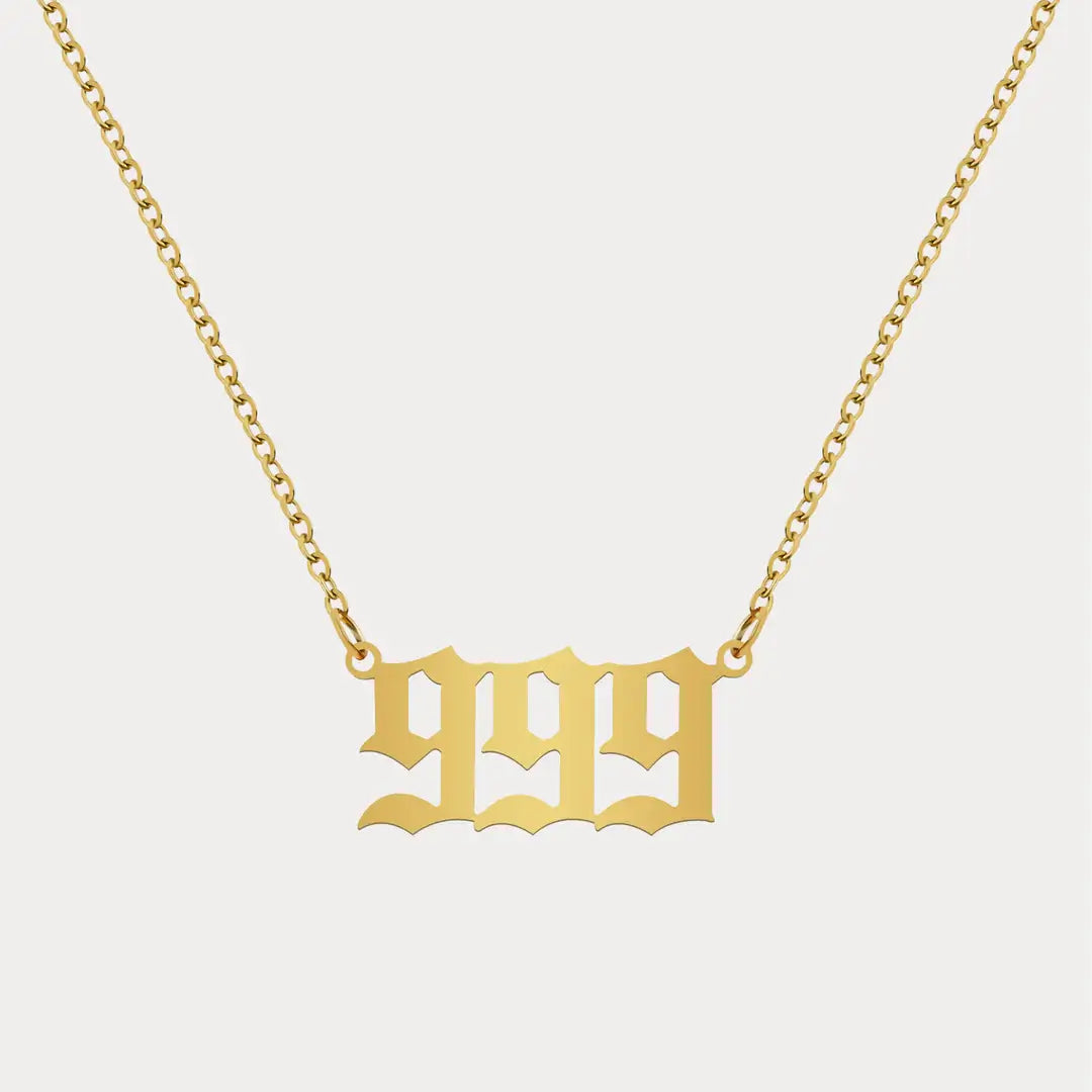 Angel Number Pendant Necklace by AUREATE showcasing a gold 999 numeral design on a delicate chain.