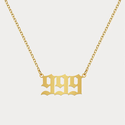 Angel Number Pendant Necklace by AUREATE showcasing a gold 999 numeral design on a delicate chain.