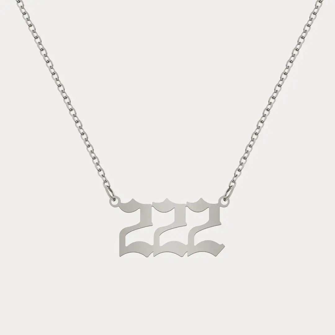 Angel Number Pendant Necklace by AUREATE featuring a silver 222 charm on a delicate chain.