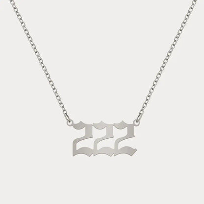 Angel Number Pendant Necklace by AUREATE featuring a silver 222 charm on a delicate chain.