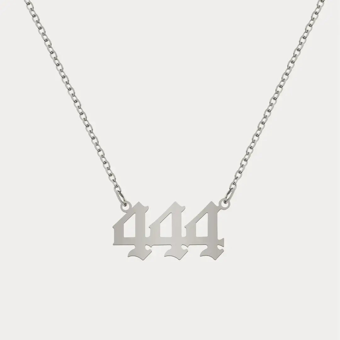 Angel Number Pendant Necklace by AUREATE featuring a silver design with the number 444.