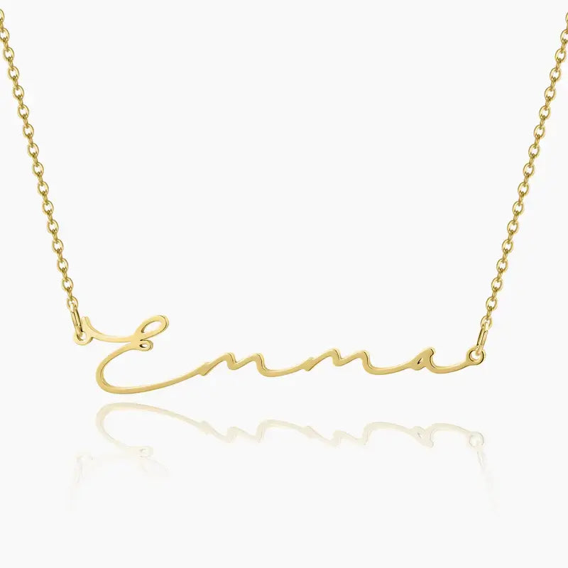 Aureate Petit Name Necklace in gold with personalized name 'Emma', sleek and elegant design for minimalist style.