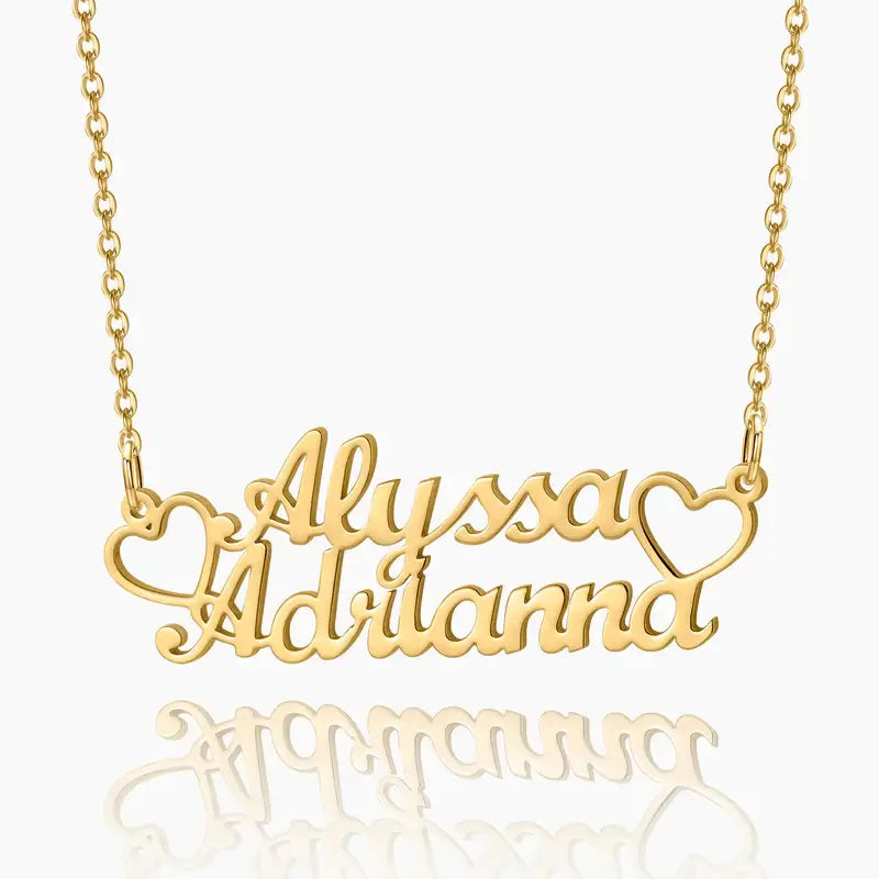 AUREATE Two Name Necklace featuring gold script names Alyssa and Adrianna with heart accents.