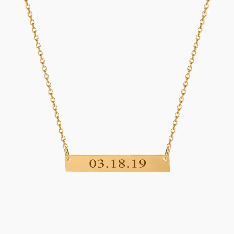 AUREATE Bar Necklace with Engraving featuring the date 03.18.19 on a sleek gold horizontal bar.
