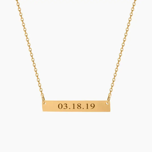 AUREATE Bar Necklace with Engraving featuring the date 03.18.19 on a sleek gold horizontal bar.
