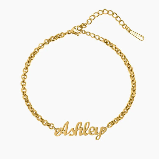 Personalised Name Bracelet by AUREATE, featuring a gold chain with the name 'Ashley' in a stylish design.