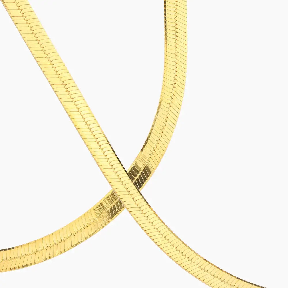 5mm Herringbone Chain by AUREATE, showcasing a sleek, liquid-gold design that captures high-shine surface textures.