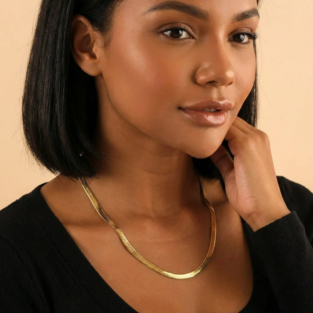 AUREATE 5mm Herringbone Chain elegantly displayed on a model, highlighting its liquid-gold shine and modern design.