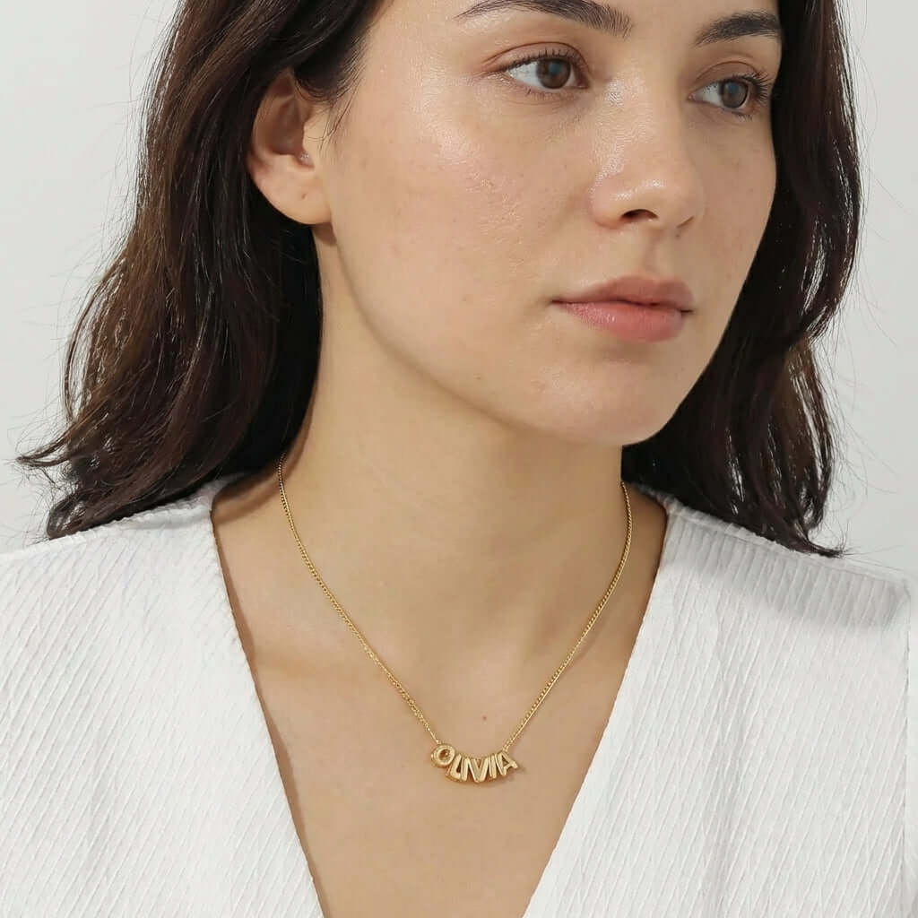Bubble Style Name Necklace by AUREATE showcased on model, capturing the playful and polished design of 2026 trends.