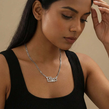 AUREATE Diamond Cut Heart Name Necklace worn by a woman, showcasing the personalized name 'Oliver' in a stylish setting.