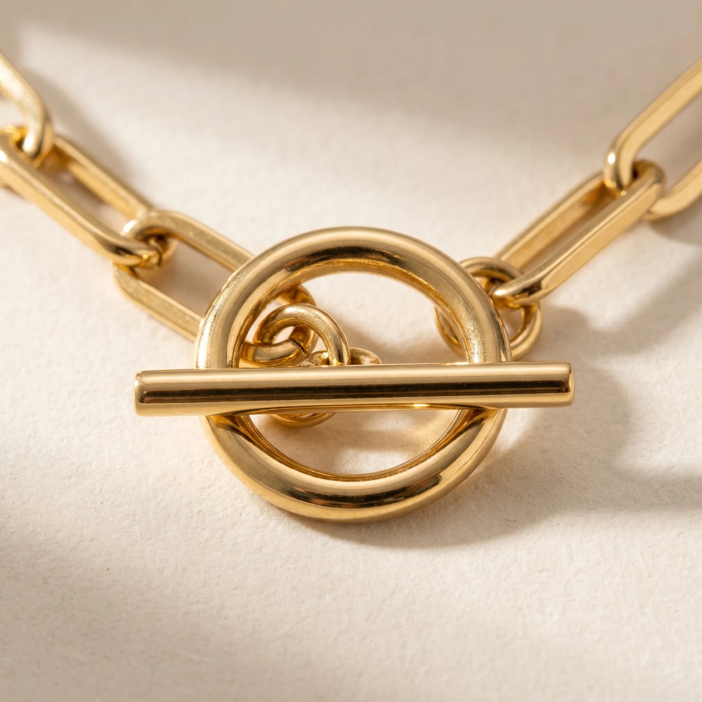 Paperclip toggle necklace gold T-bar clasp macro detail showing hardware