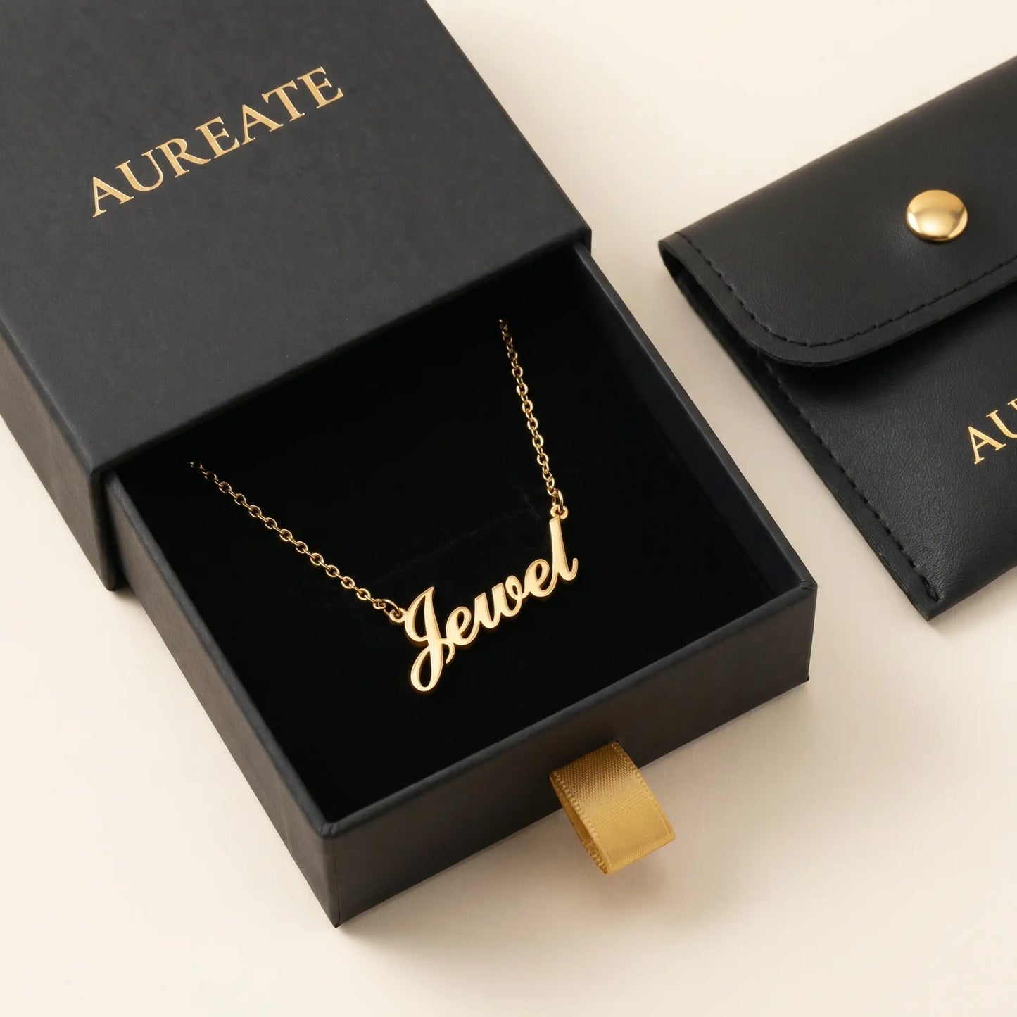 Personalised Plate Chain in 18K Gold by AUREATE, featuring the name Jewel in elegant script on a gold necklace.