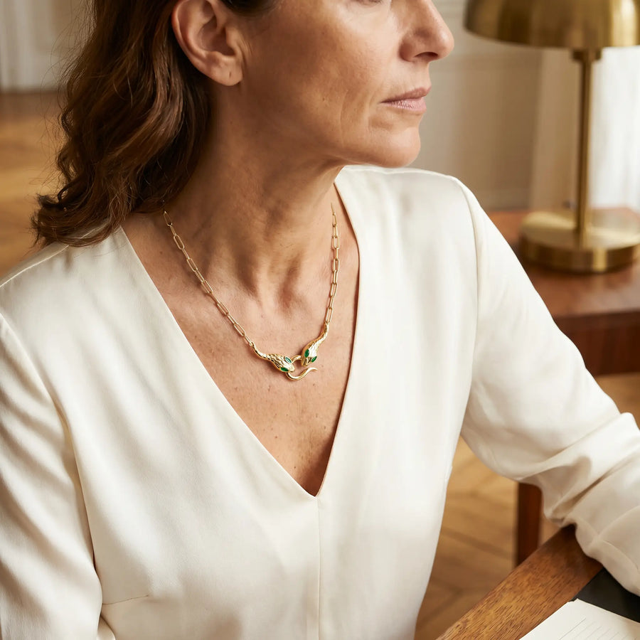 Snake pendant necklace mature elegance studio portrait - gold serpent choker ivory blouse