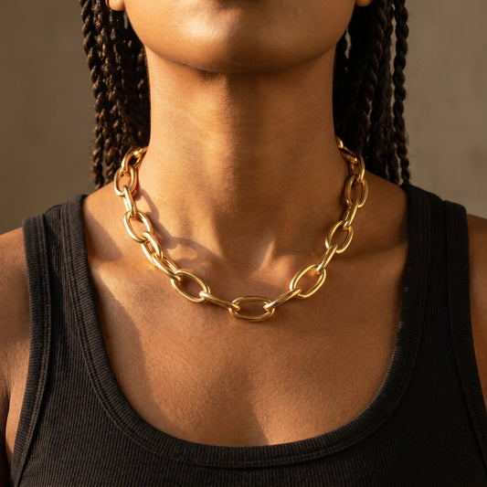 Chunky gold statement necklace XL oval cable chain worn close-up base of throat