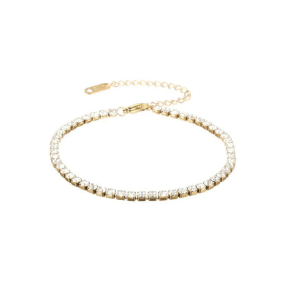 Aureate Classic Tennis Bracelet featuring a gold chain with sparkling clear gemstones, ideal for a timeless luxury look.