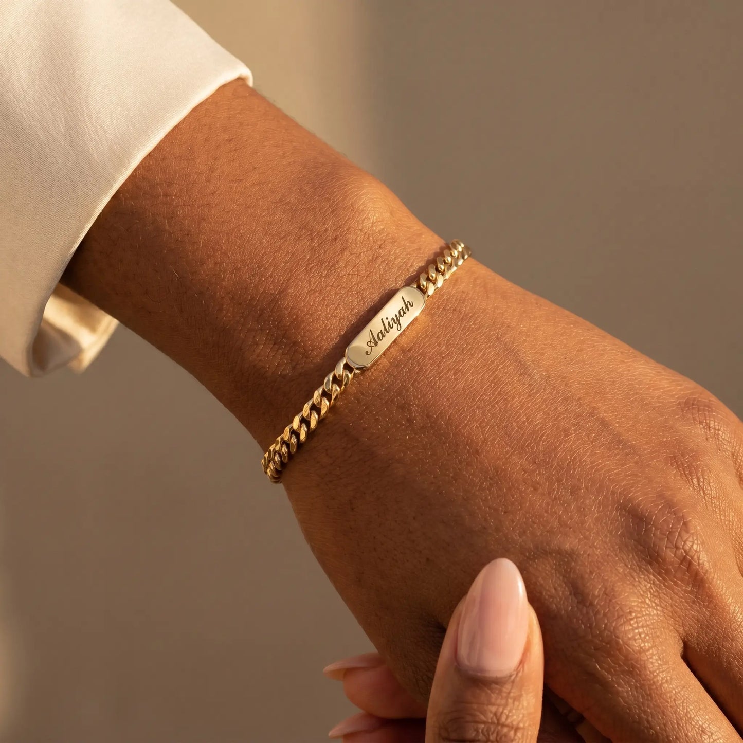 Cuban Bar Engraved Bracelet 18K Gold worn close-up at wrist Aaliyah