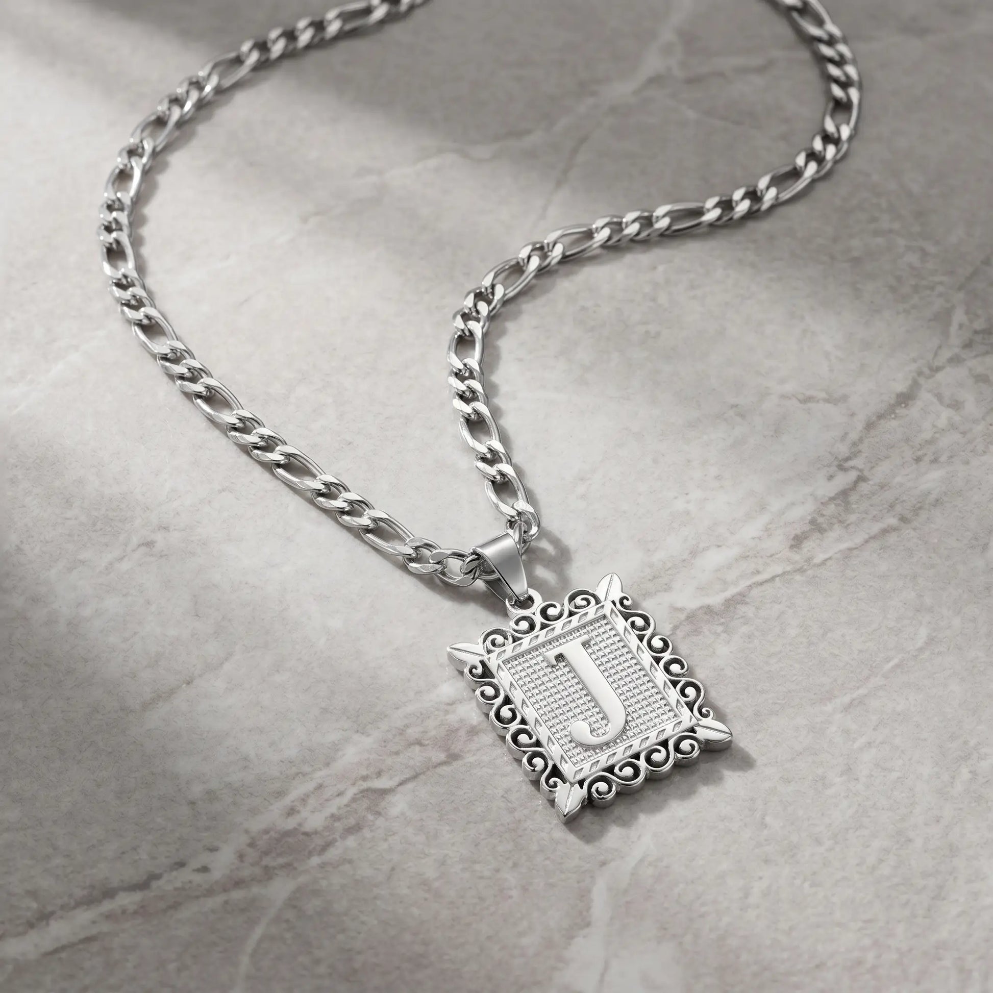Raised Initial Figaro Pendant silver tone packshot on cool stone