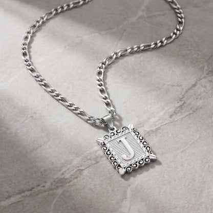 Raised Initial Figaro Pendant silver tone packshot on cool stone