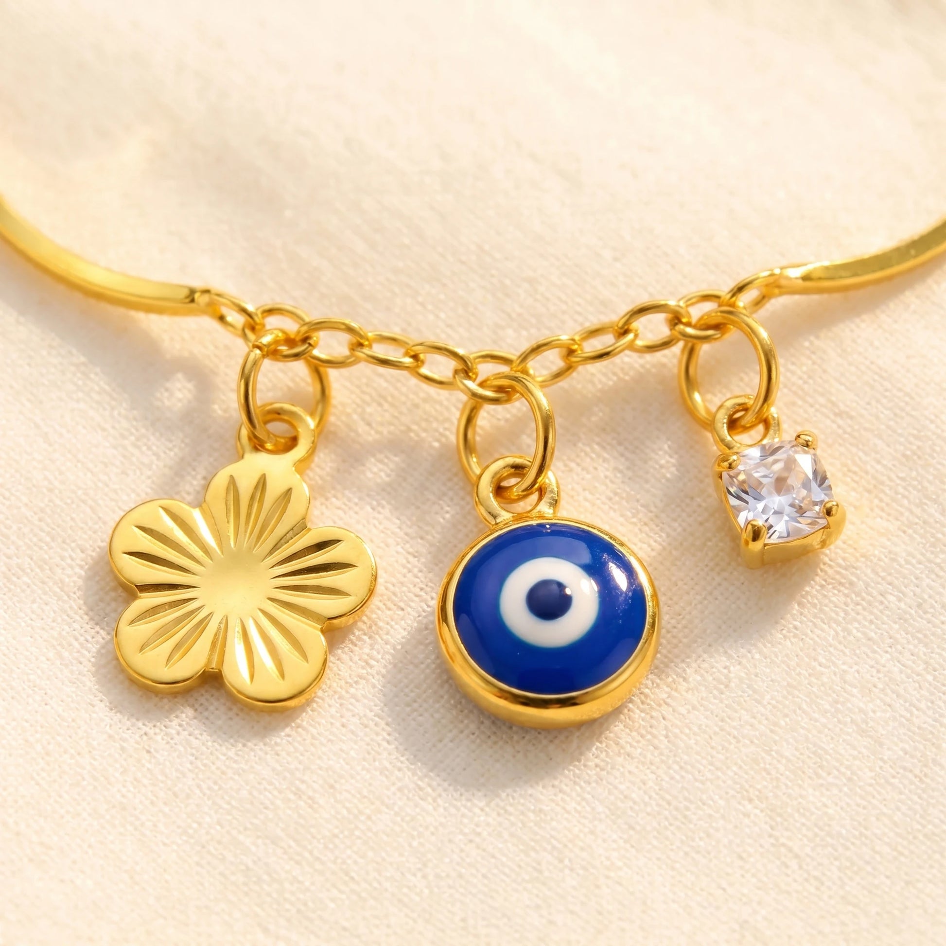 Evil Eye Flower Anklet macro - flower + blue evil eye + crystal dangling