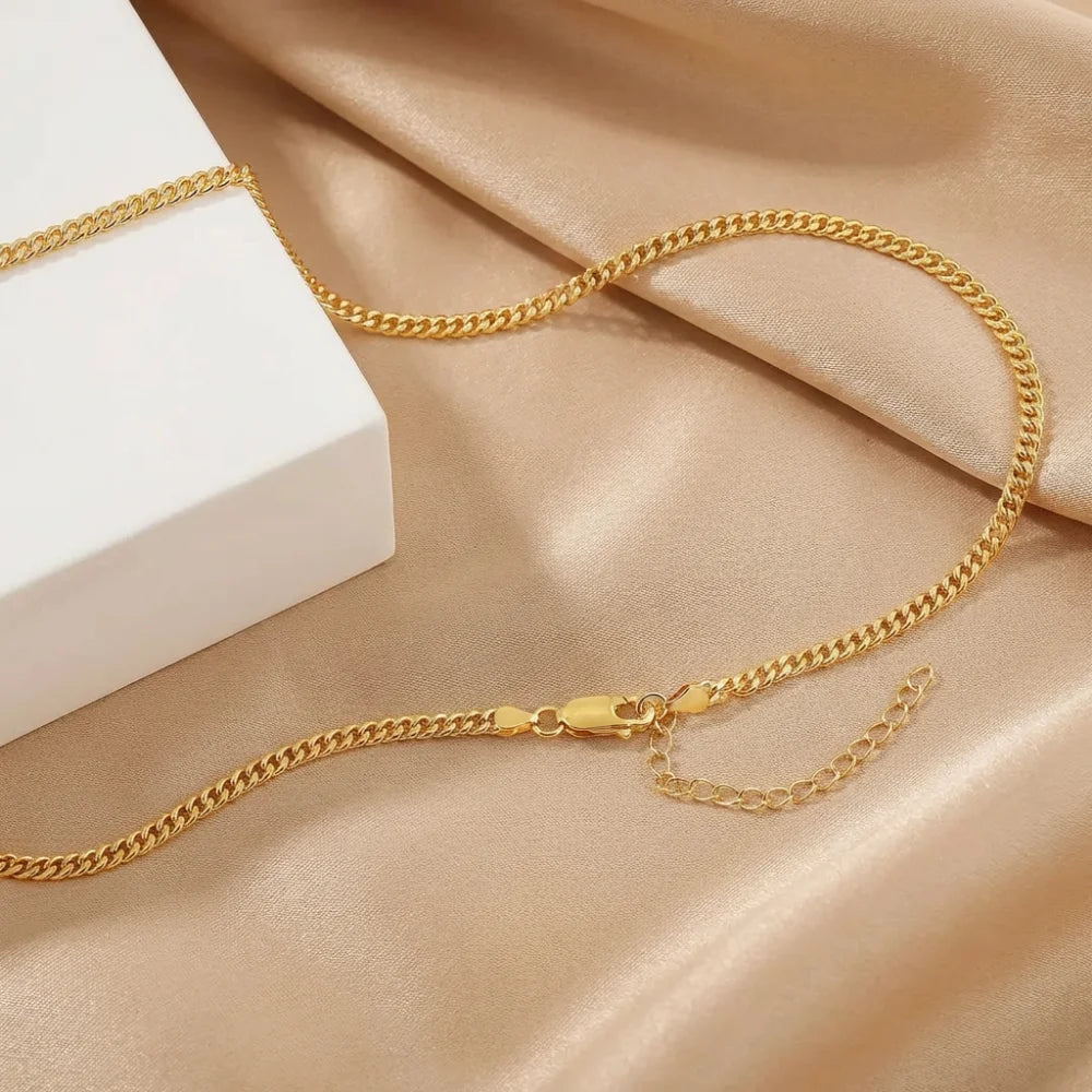Gold chain necklace on satin with gift box