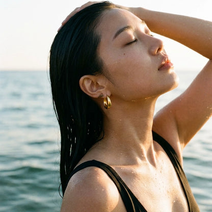 18K gold plated chunky dome hoop earrings, worn in the water at golden hour | SKU: AUR-CHKDOM-G
