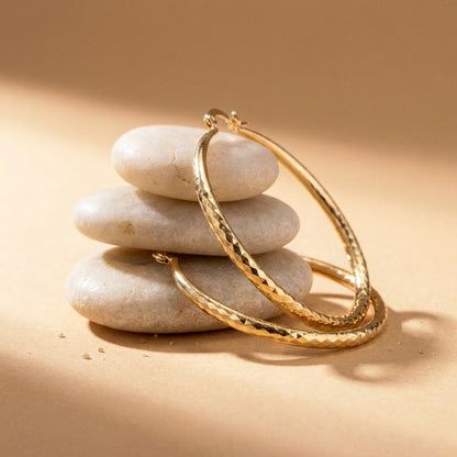18K gold plated diamond cut large hoop earrings, still life on smooth stones | SKU: AUR-DCTHOP-G