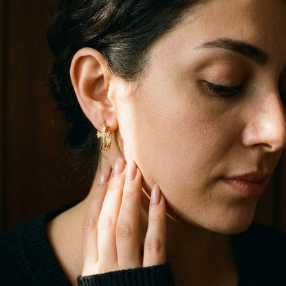 18K gold plated pave cross huggie hoop earrings, worn, close detail in warm light | SKU: AUR-CRXHUG-G
