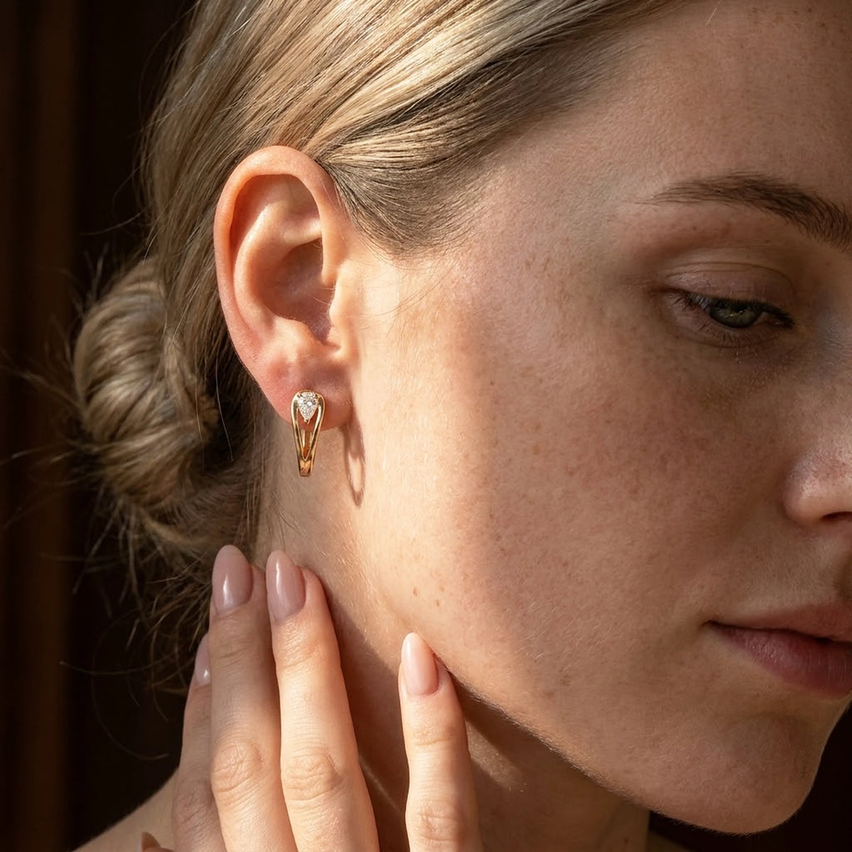 18K gold plated pear cut crystal huggie hoop earrings, worn, close detail in warm light | SKU: AUR-PRCZHG-G