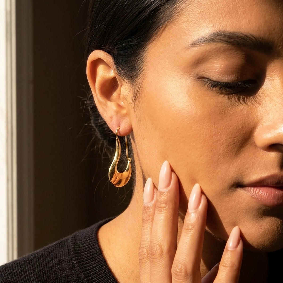 18K gold plated sculpted crescent drop earrings, worn, close detail in warm light | SKU: AUR-SCPCRS-G