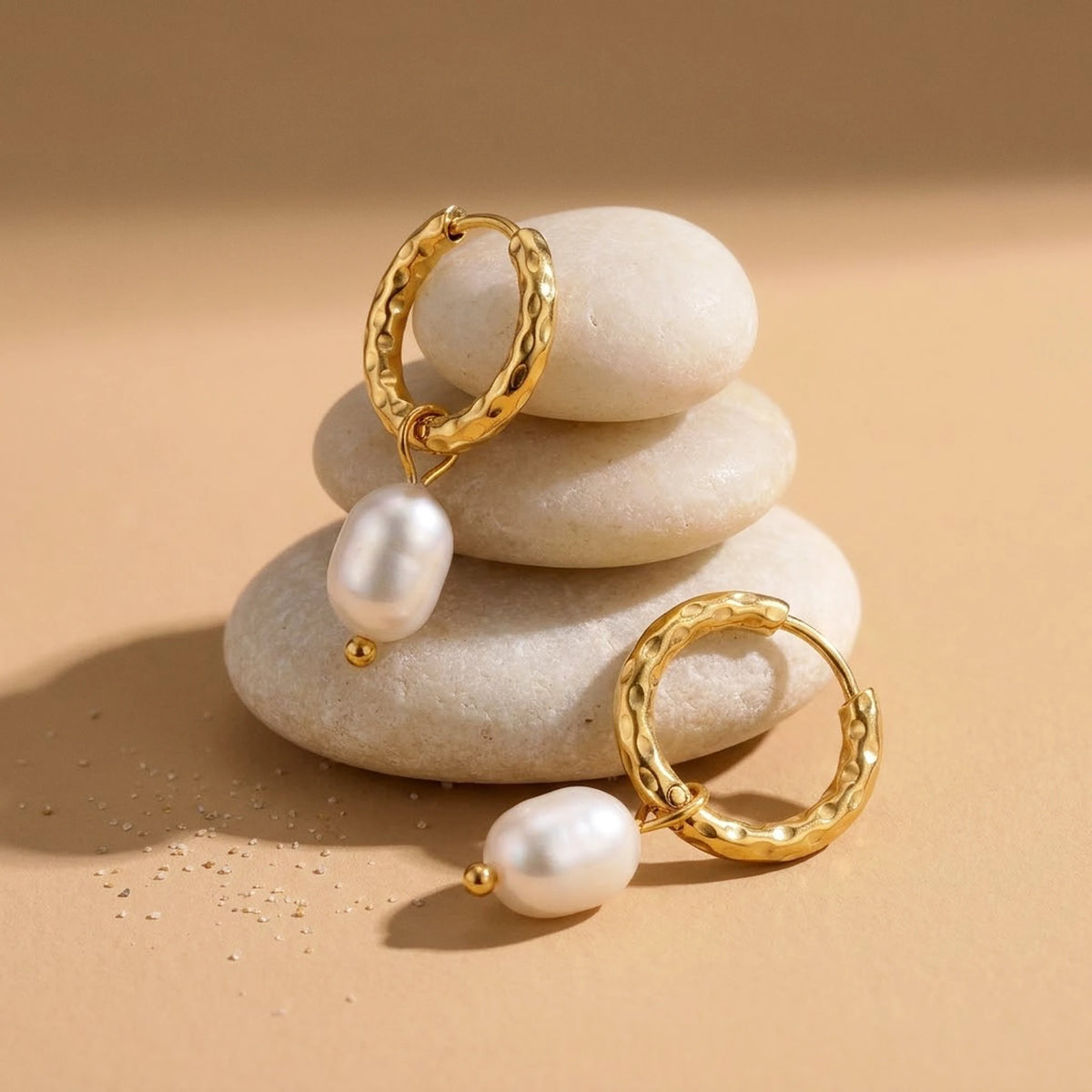 18K gold plated twisted rope pearl drop hoop earrings, still life on smooth stones | SKU: AUR-TWPRLH-G