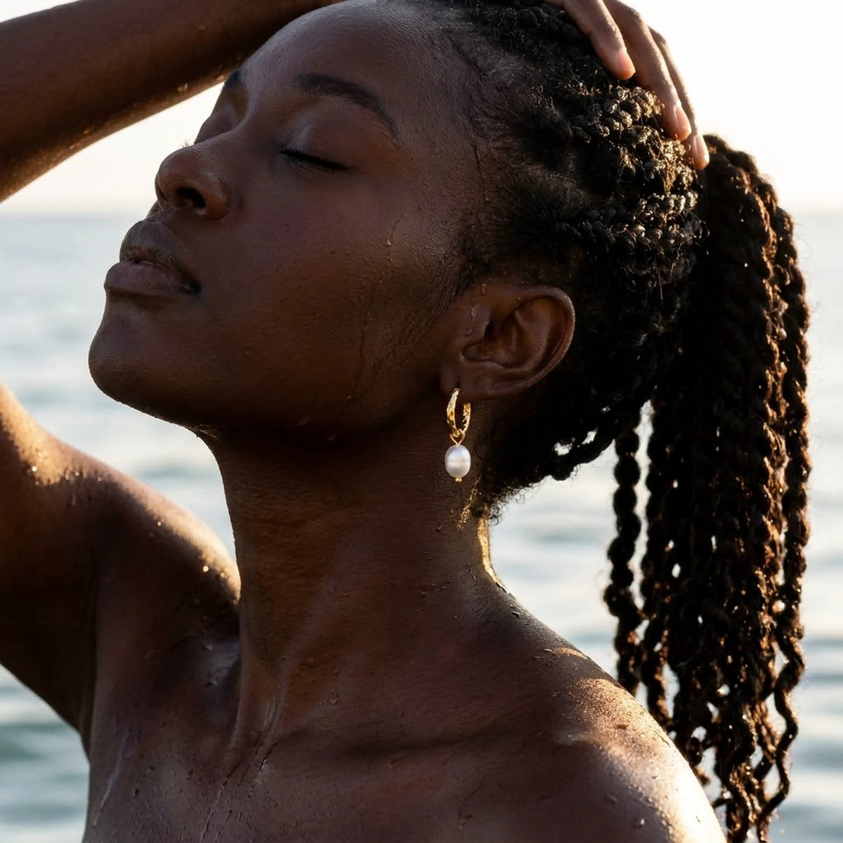 18K gold plated twisted rope pearl drop hoop earrings, worn in the water at golden hour | SKU: AUR-TWPRLH-G