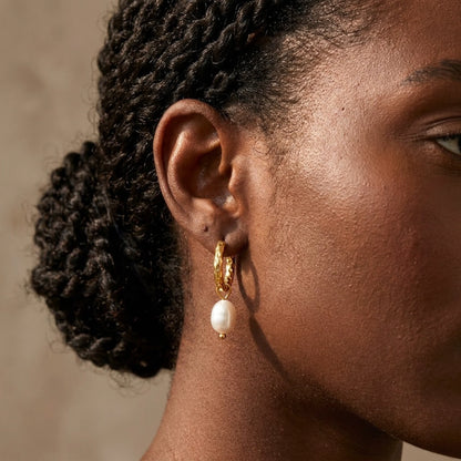 18K gold plated twisted rope pearl drop hoop earrings, worn close up on the ear