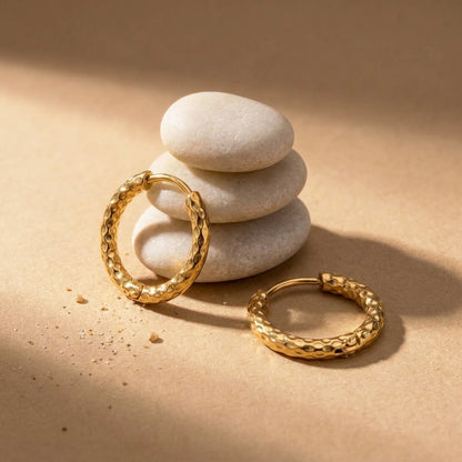 18K gold plated twisted rope huggie hoop earrings, still life on smooth stones | SKU: AUR-TWRHUG-G