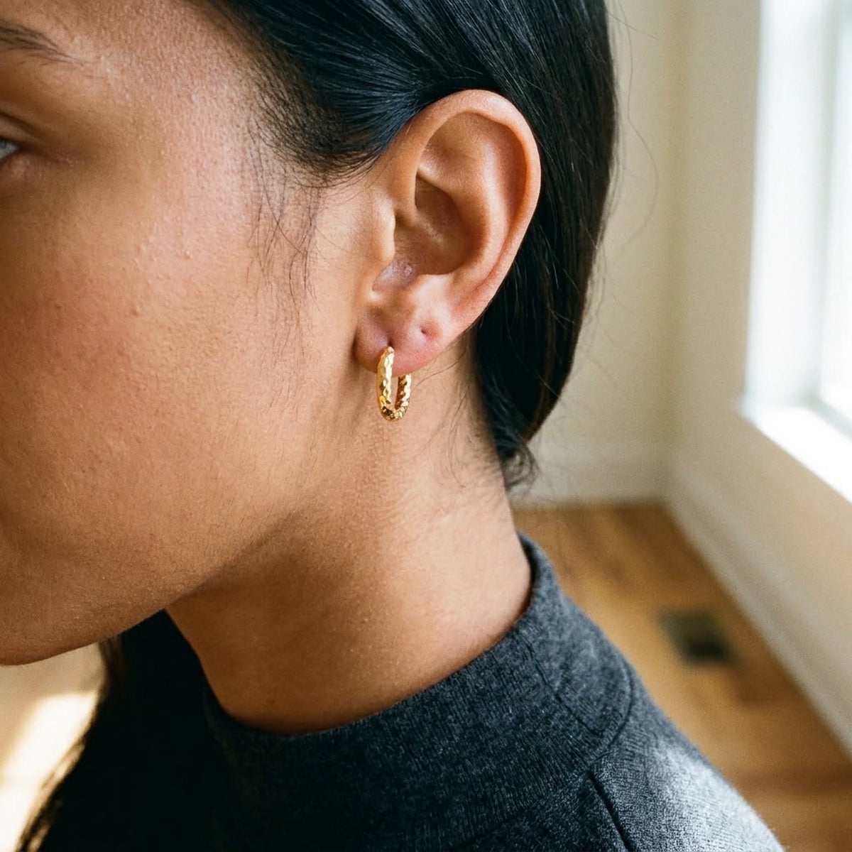 18K gold plated twisted rope huggie hoop earrings, worn, three quarter view | SKU: AUR-TWRHUG-G