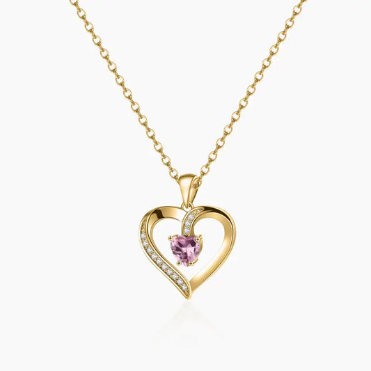 Aureate Heart Birthstone Necklace featuring a heart-shaped pendant with a pink gemstone and sparkling accents.