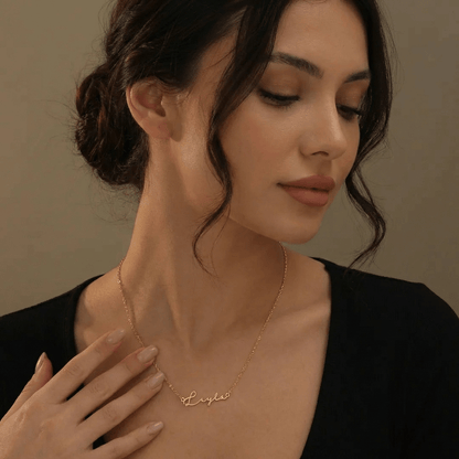 Sleek AUREATE Petit Name Necklace worn elegantly, showcasing a personalized gold design on a model.