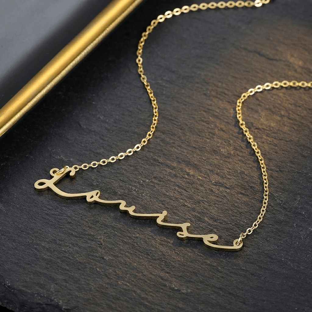AUREATE Petit Name Necklace in gold featuring a personalized name, perfect minimalist accessory for any occasion.