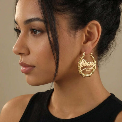 Bamboo Hoop Earrings with Heart Name featuring personalized name 'Ebony', worn by a model, showcasing AUREATE brand.