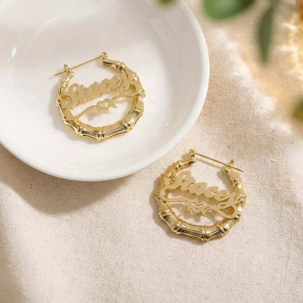 Bamboo Hoop Earrings with Heart Name featuring personalized name design by AUREATE in gold plating.