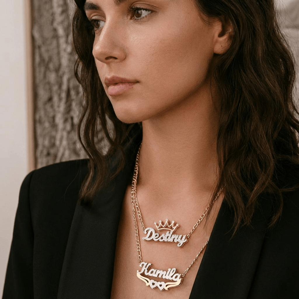 Double Plated Crown Name Necklace with Figaro Chain worn by a model showcasing custom names elegantly.