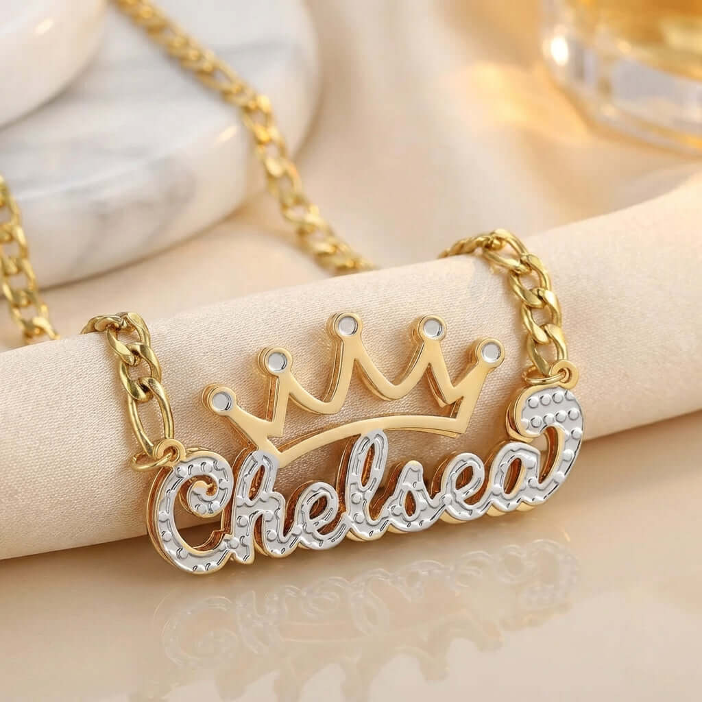 Double Plated Crown Name Necklace with Figaro Chain by AUREATE, featuring a crown design with the name Chelsea.