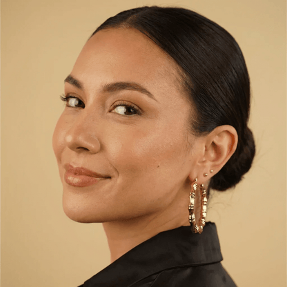 AUREATE Classic Bamboo Hoop Earrings showcased on a model, featuring a stylish design with textured gold finish.