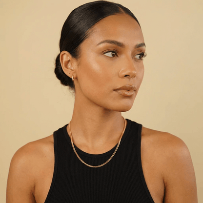 AUREATE 3mm Cuban Link Chain worn by a woman in a black tank top, showcasing elegance and style.