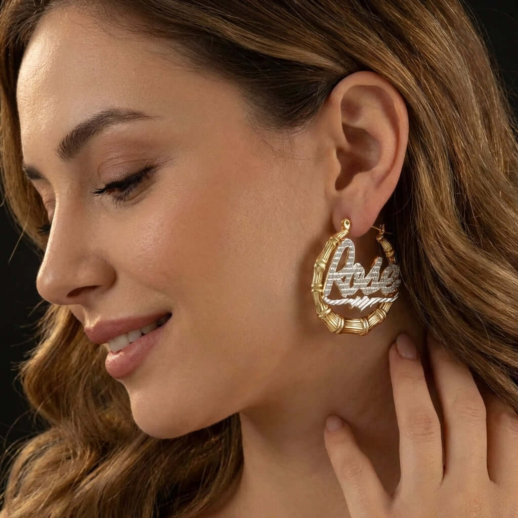 Close-up of a woman wearing AUREATE Double Plated Bamboo Name Hoops earrings with a stylish design.