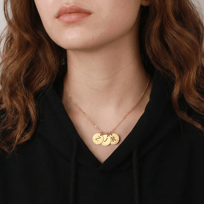 Date & Initial Charm Necklace from AUREATE showcasing personalized charms on a model's neck.