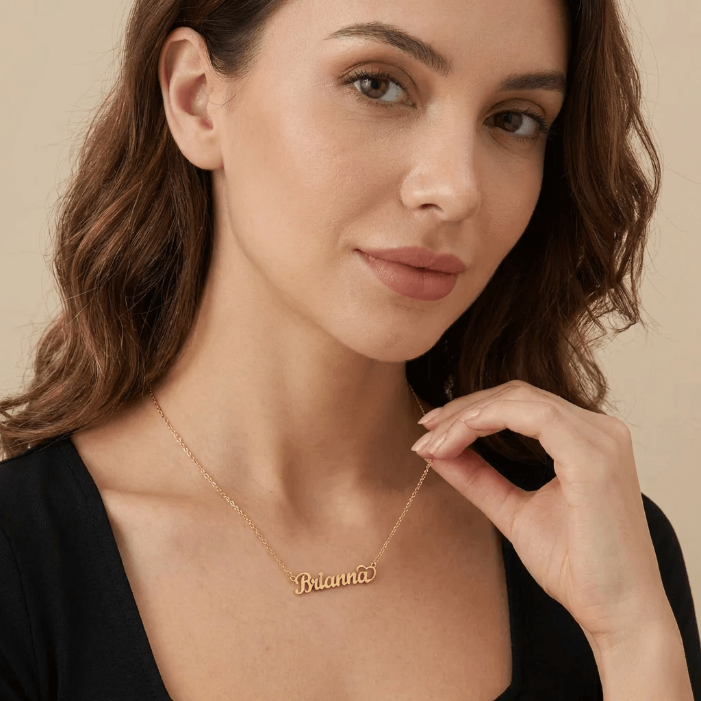 Crescent Heart Personalised Name Necklace worn by a woman, showcasing the name Brianna in elegant gold lettering by AUREATE.