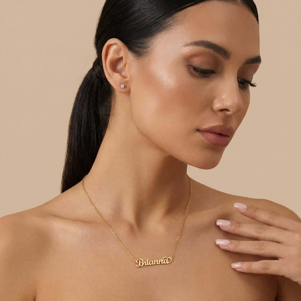 Crescent Heart Personalised Name Necklace worn by a model, featuring the name 'Brianna' in elegant gold design by AUREATE.