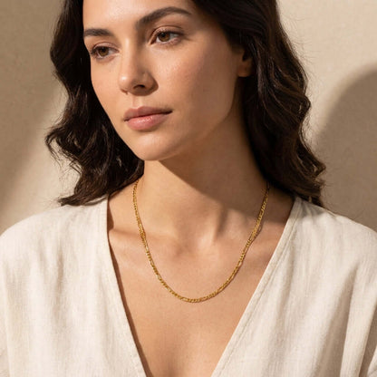 AUREATE 3mm Figaro Chain Necklace worn by a model, showcasing its elegant design and layering potential.