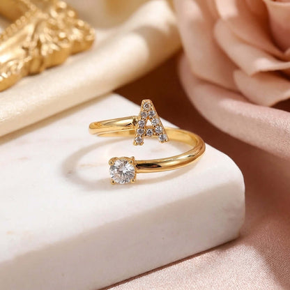 Iced Initial Signet Ring by AUREATE featuring sparkling 'A' design and a diamond-like stone.