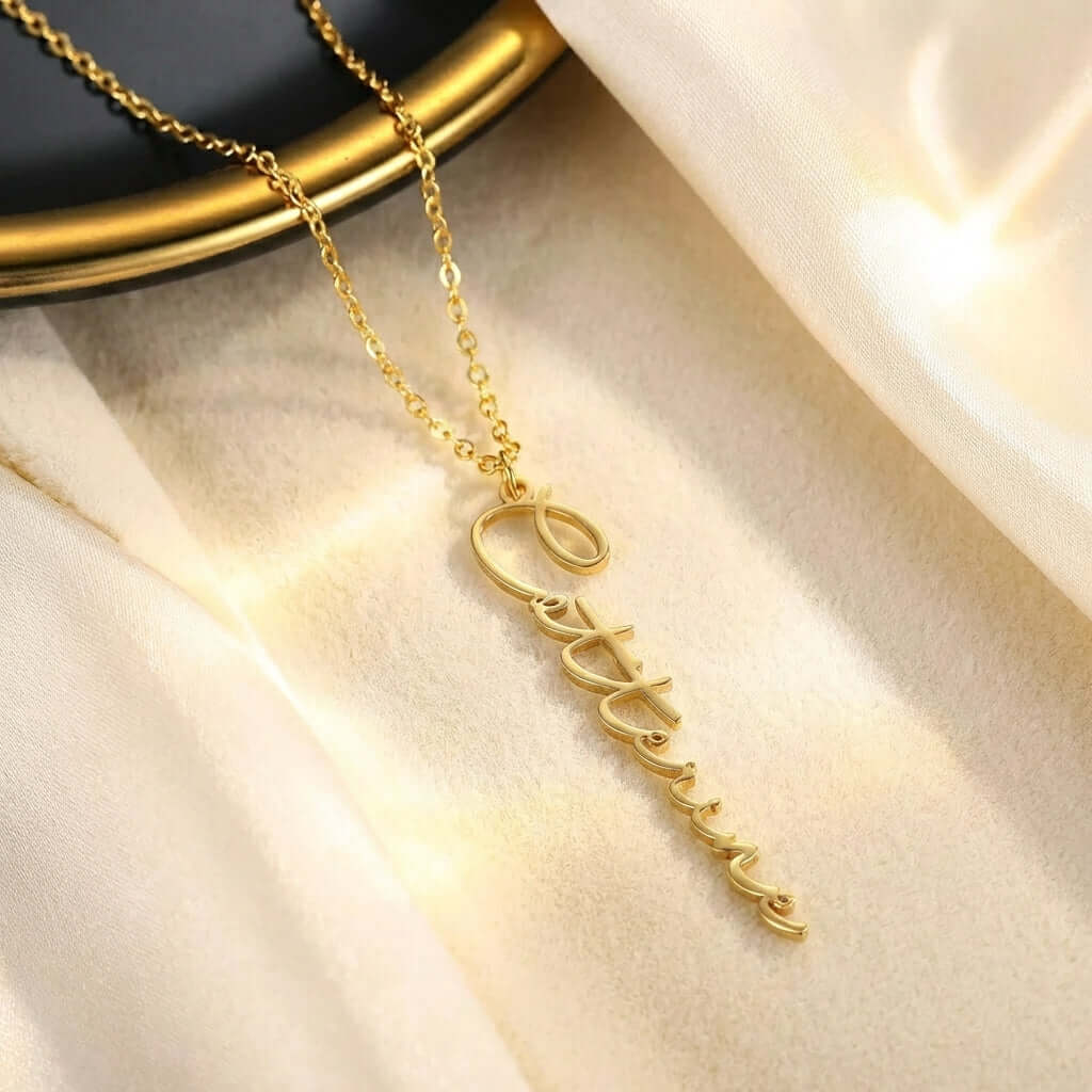 Vertical Personalised Necklace by AUREATE, featuring an elegant gold name pendant on a chain.